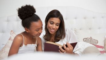 Mother and daughter reading Bible together