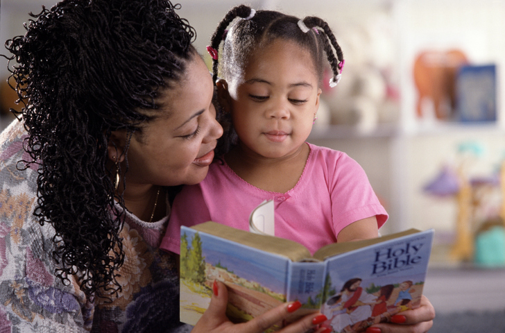 Woman and girl reading the Bible